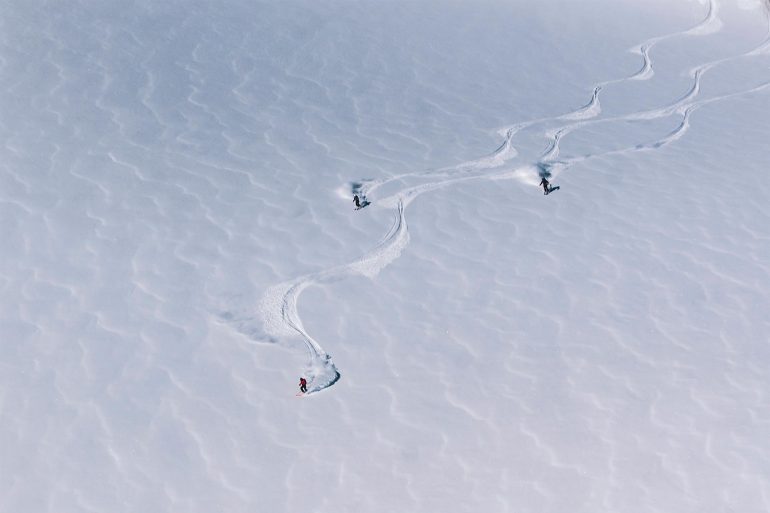 A group of skiers go down a mountain in Swedish Lapland, Sweden