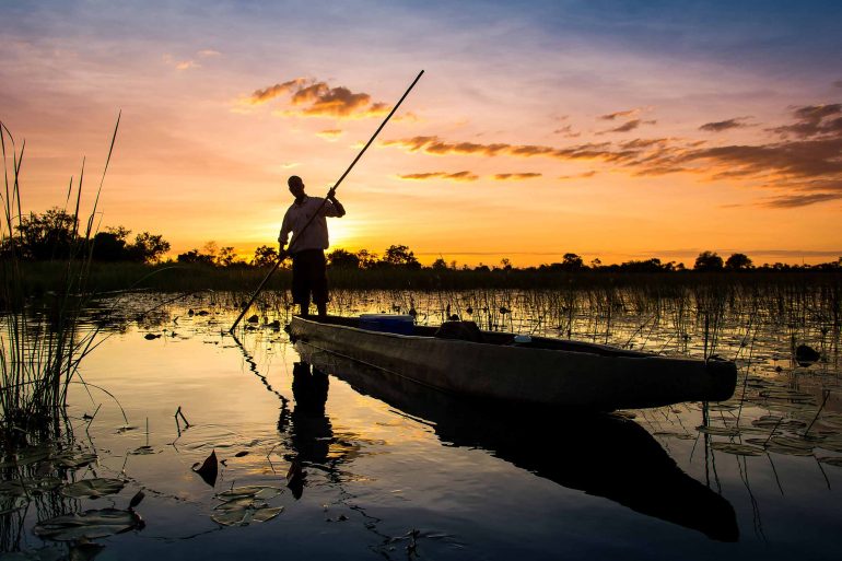 A boatman on the water in the Moremi Game Reserve, Botswana