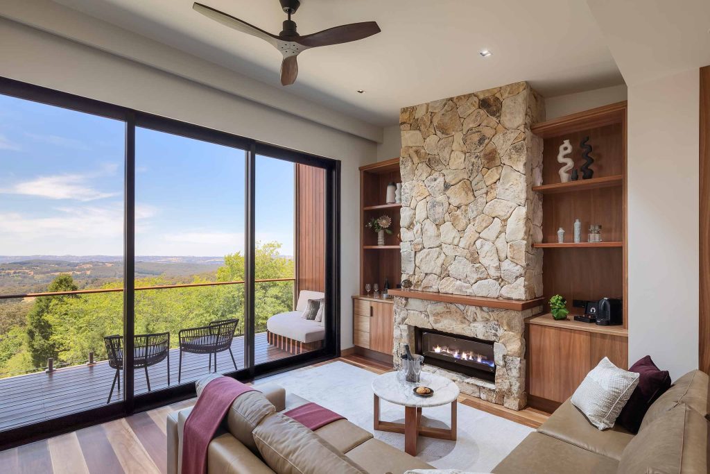 A cozy seating are with a fireplace and spellbinding vistas