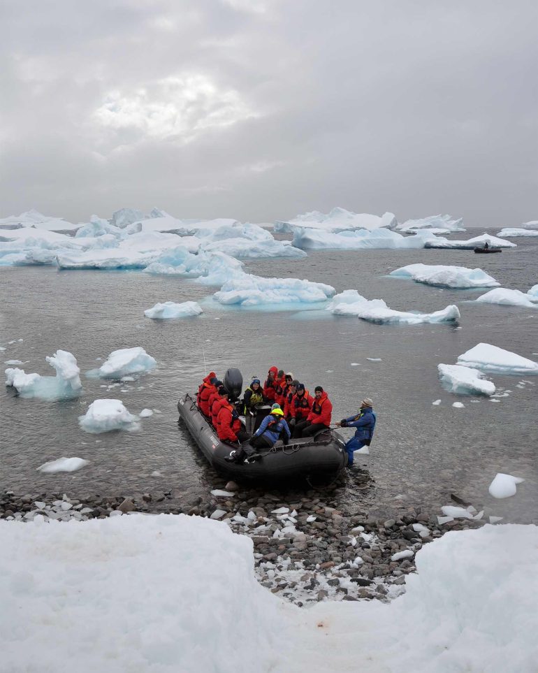 A zodiac boat arrives ashore in Antartica