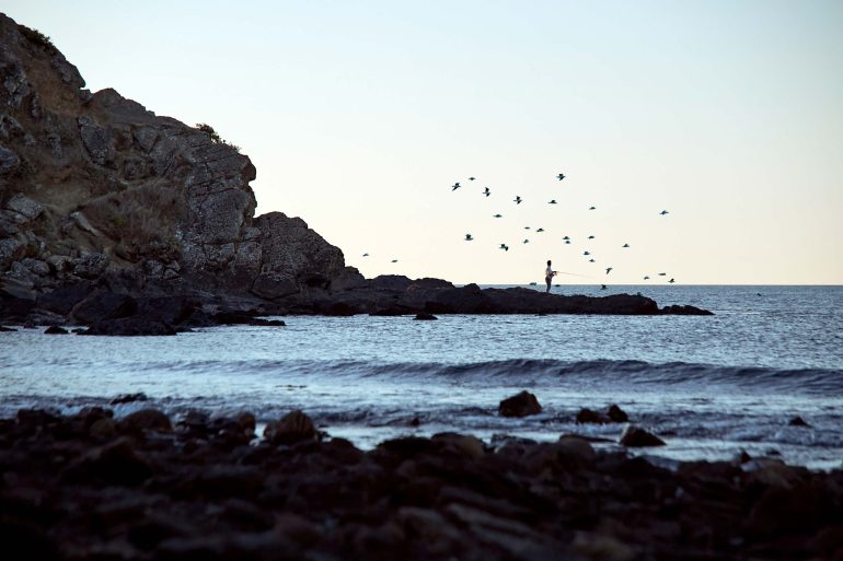 A sole figure by the sea in Myponga Beach, Australia