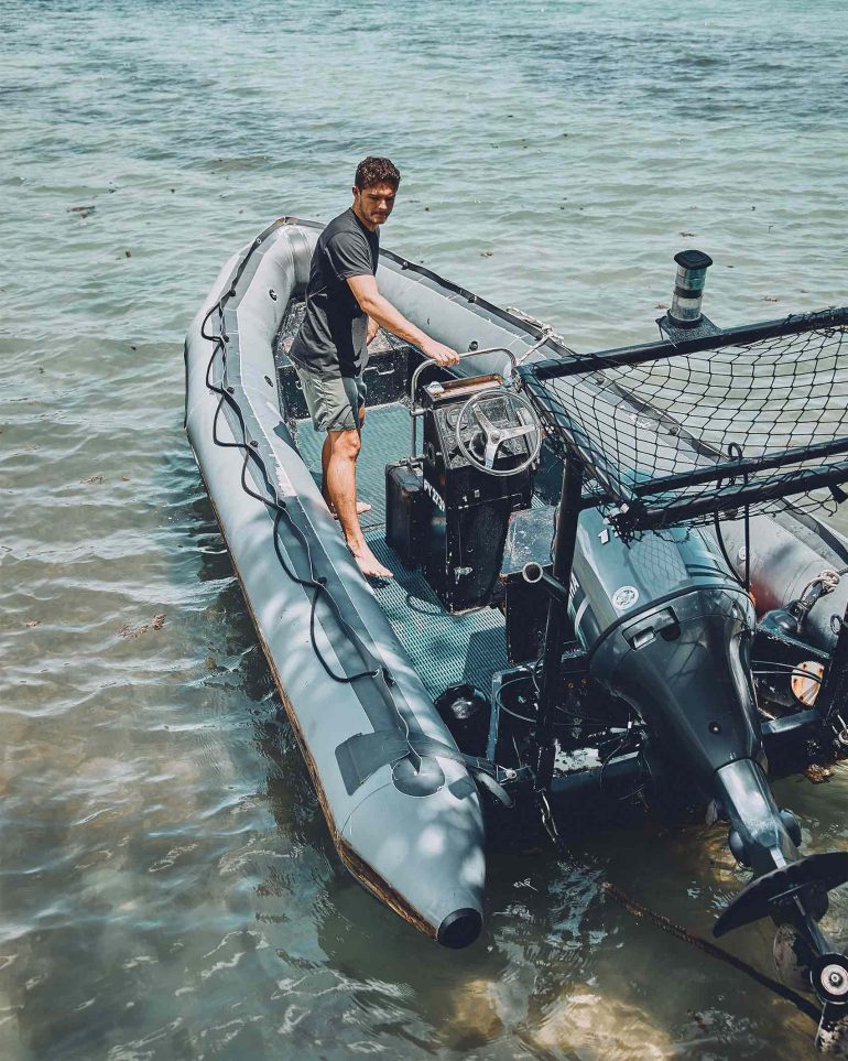 A local man on a boat in The Islands of Tahiti, French Polynesia