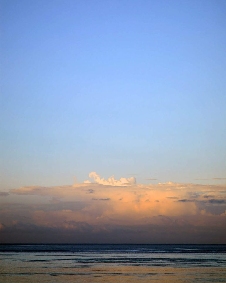 The sun sets over the sea in The Islands of Tahiti, French Polynesia