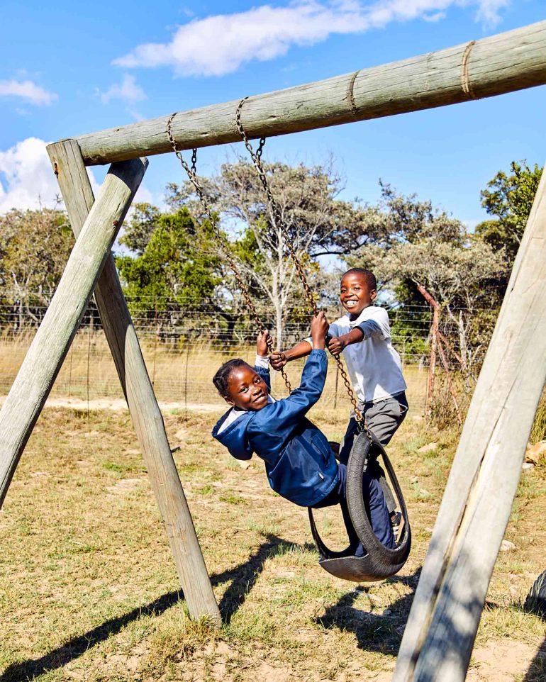 Local school children play near the Shambala Private Game Reserve, South Africa