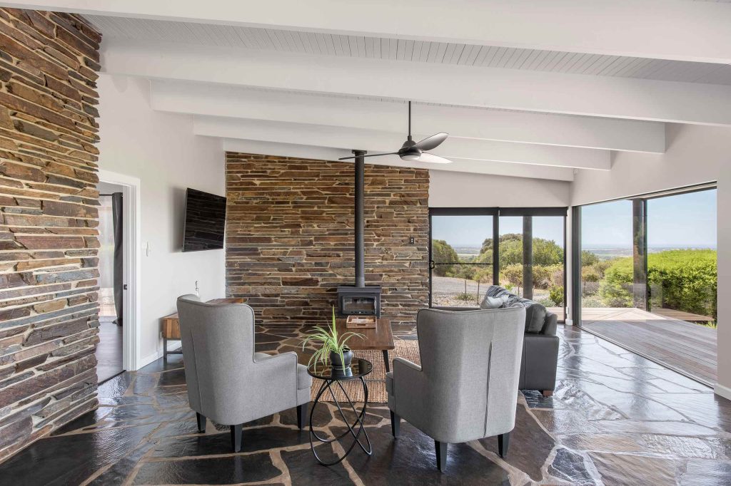 Bright lounge area with a fireplace and panoramic windows at Weemilah Luxury Retreat, McLaren Vale, Australia