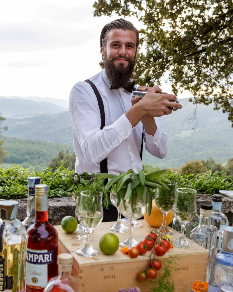 A mixologist prepares a cocktail at the Borgo Pignano, Tuscany, Italy