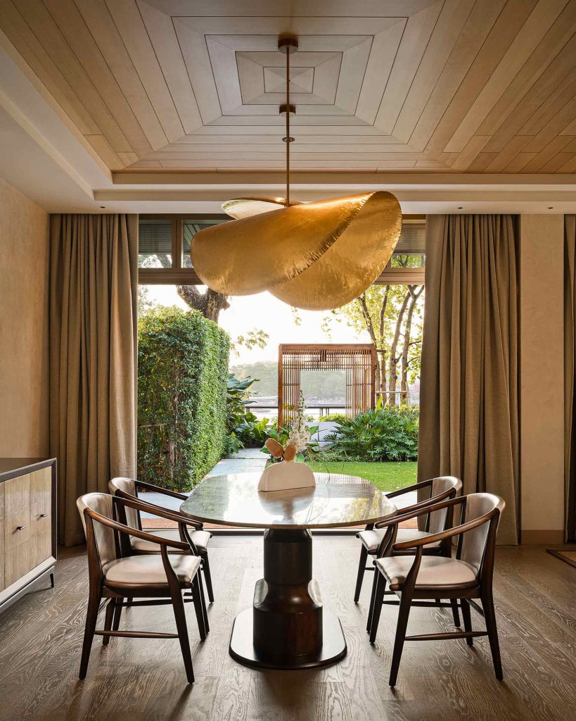 A dining table with views of the garden at Capella Bangkok, Thailand