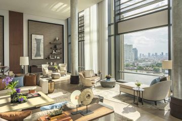 A sophisticated, brightly lit lounge with river views at Four Seasons Bangkok at Chao Phraya River, Bangkok, Thailand