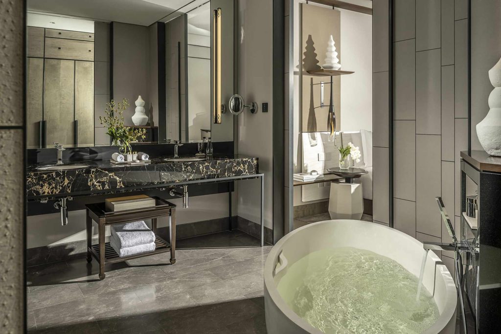 A stylish bathroom with a freestanding bathtub and a large mirror