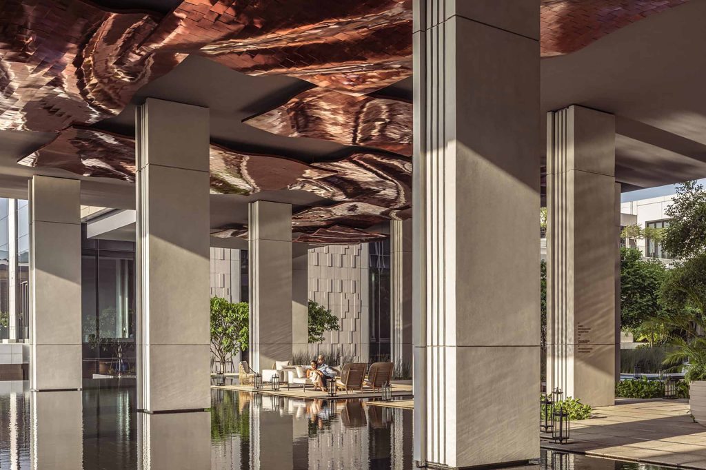 A contemporary lounge area with copper ceiling panels at Four Seasons Bangkok at Chao Phraya River, Bangkok, Thailand