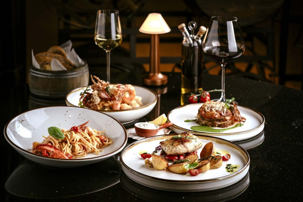 Four dishes of carefully plated Italian meals at a high-end restaurant 