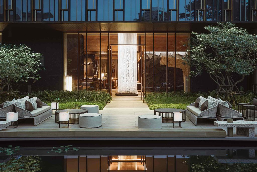 A carefully designed outdoor seating area beside a water feature at Kimpton Maa-Lai Bangkok, Bangkok, Thailand