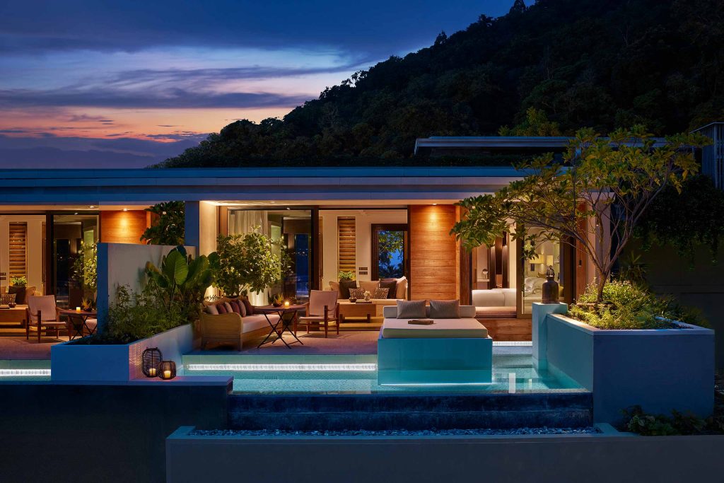 External views of the Rosewood Phuket, perched in the hills at night time.