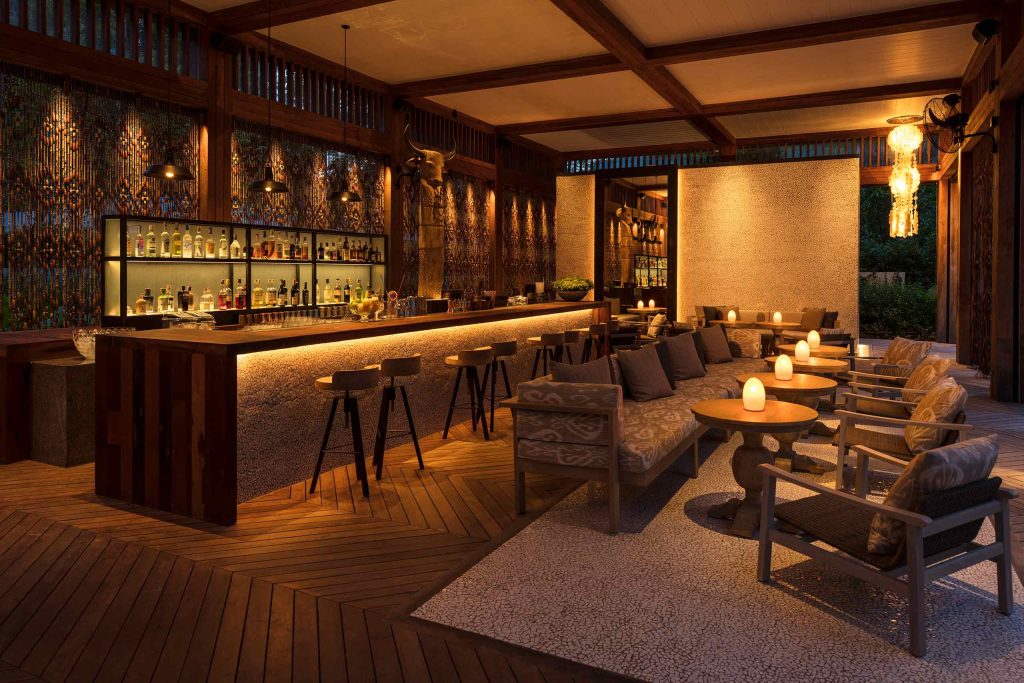 A romantically lit bar/restaurant with natural wood furnishings.