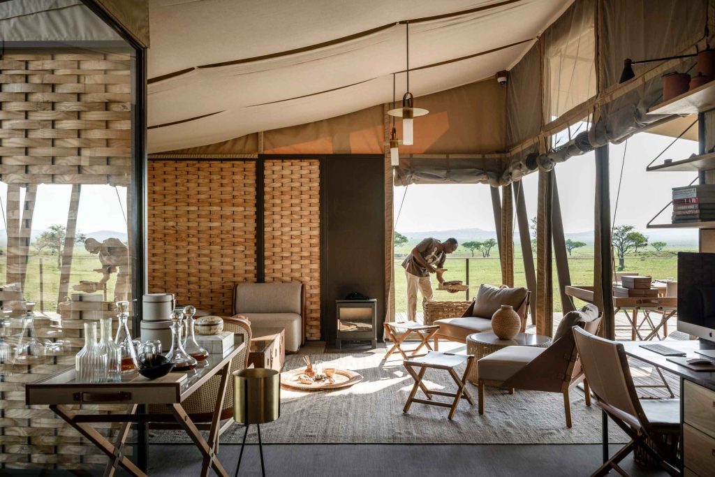A staff member prepares a room to welcome guests to the Singita Sabora Tented Camp, Grumeti Game Reserve, Tanzania