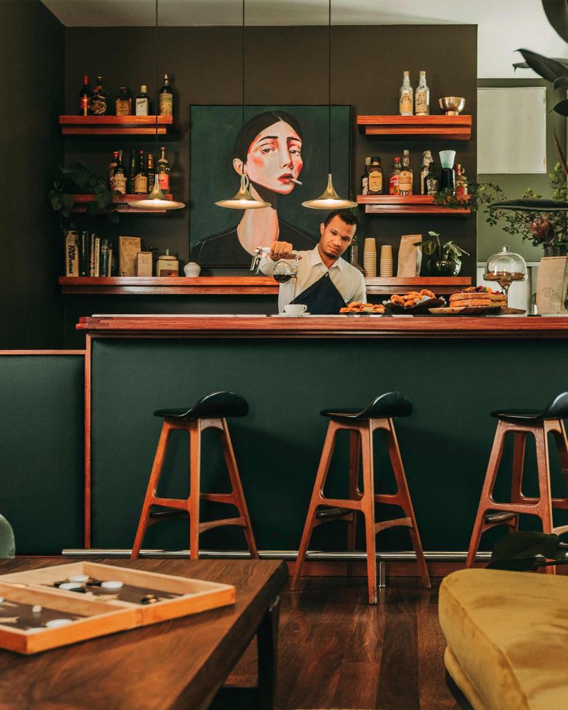 A staff member pours a cup of coffee at V Rooftop Bar, Lisbon, Portugal