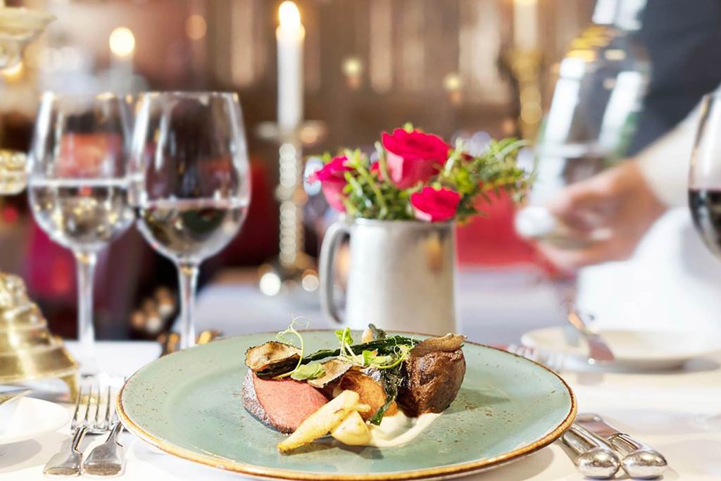 A carefully crafted plate of red meat and vegetables at a fine-dining restaurant.