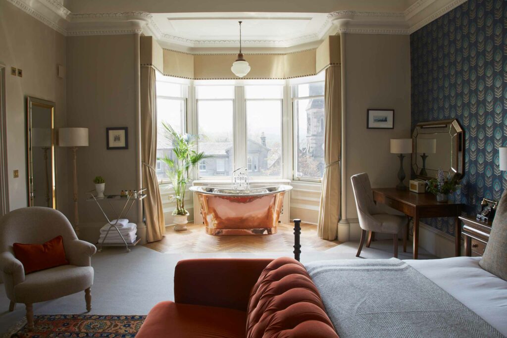 A suite with a freestanding bathtub at The Roseate, Edinburgh. Stay during the The Edinburgh Festival Fringe.