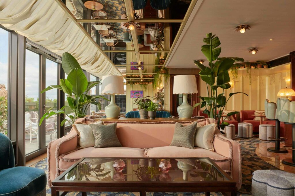 A lounge area with a pink sofa at Gleneagles Townhouse, Edinburgh.
