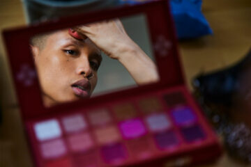 A partygoer gets ready for Amsterdam Pride, Amsterdam, The Netherlands