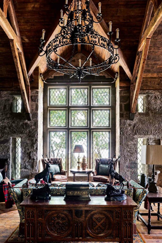A lounge area with a large window and rustic chandelier. 