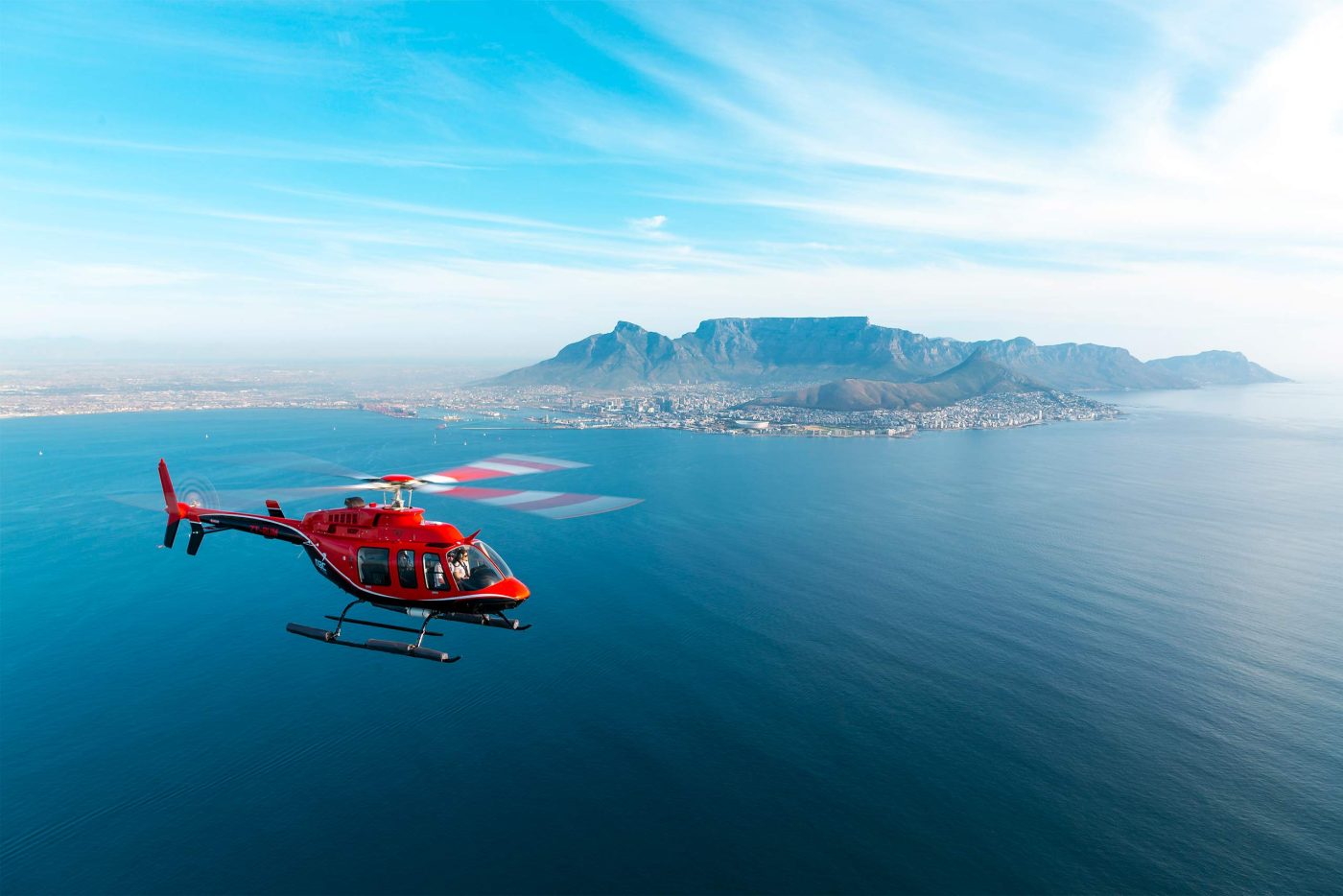 A helicopter by NAC Helicopters flies over Cape Town, Western Cape, South Africa