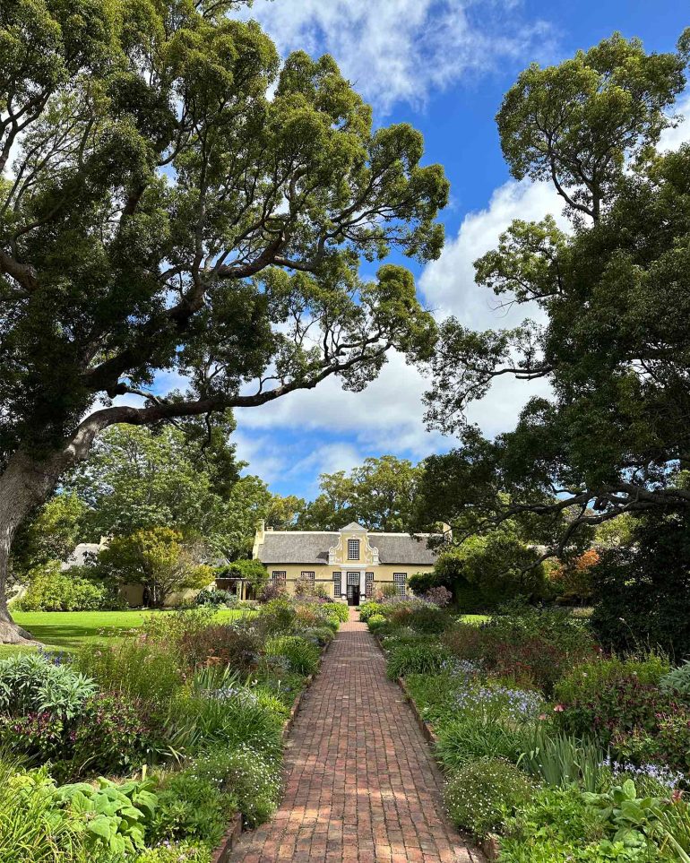 A heritage building surrounded by lush vegetation at Vergelegen Wine Estate, Western Cape, South Africa