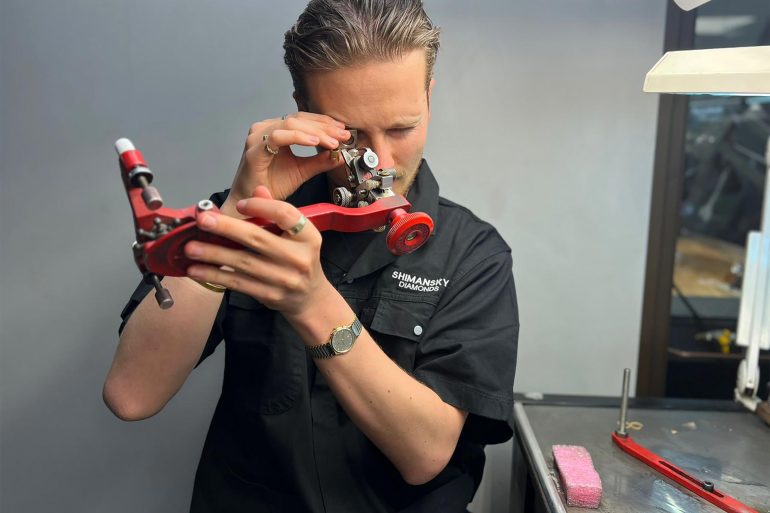 Steffen Michels takes a closer look at a diamond before polishing it at Shimansky, Cape Town, Western Cape, South Africa