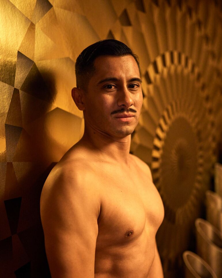 David Padilla poses in front of a golden wall at the Los Angeles Theatre in California, USA
