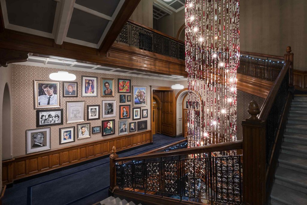 A staircase with framed paintings on the walls.