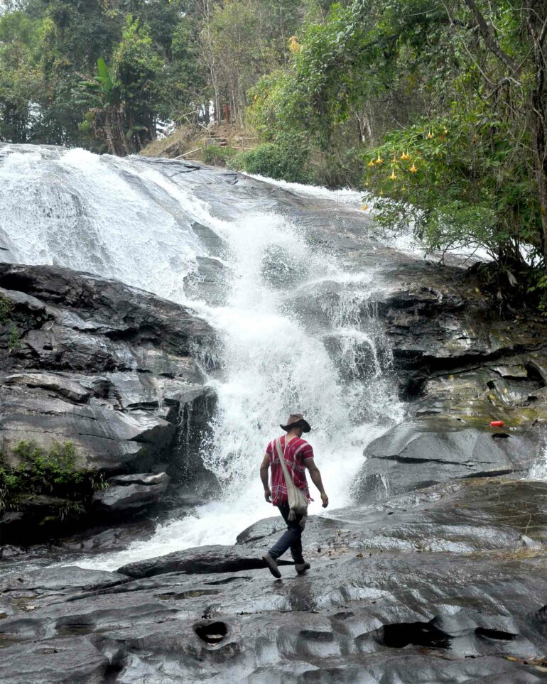 Nu, a Pakayaw tribesman, at a waterfall outside Chiang Mai, Thailand