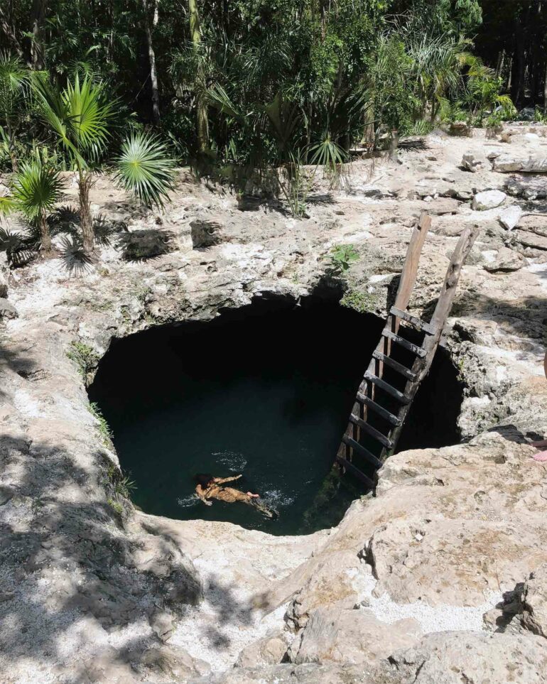 A woman swims in a cenote on the Riviera Maya, Mexico
