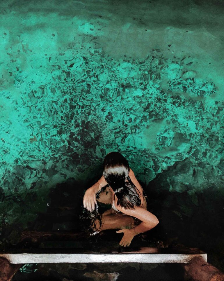 A woman prepares to swim in a cenote on the Riviera Maya, Mexico