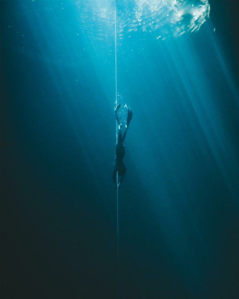 A woman freedives into a cenote on the Riviera Maya, Mexico