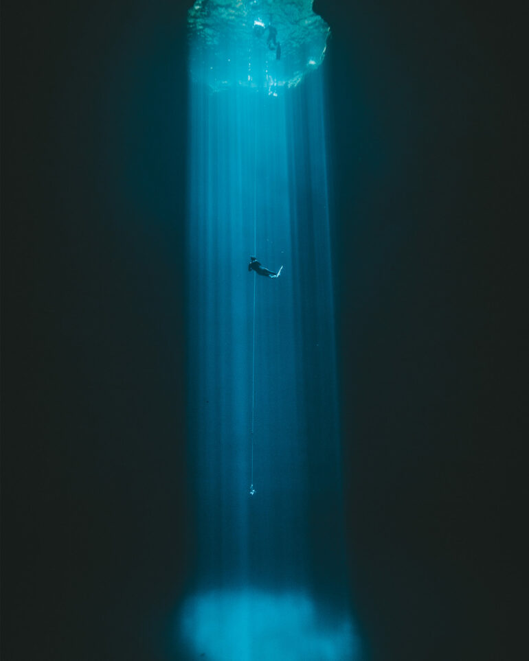 Light shines into the depths of a cenote on the Riviera Maya, Mexico