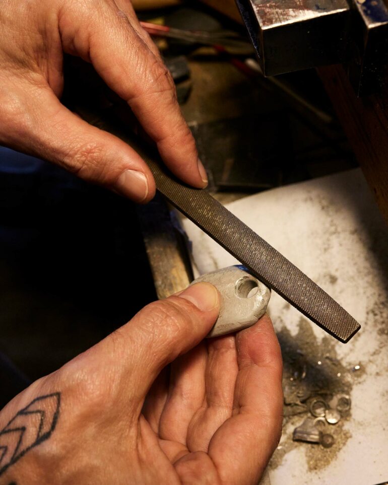 Dax Savage's hands creating a piece of jewellery.