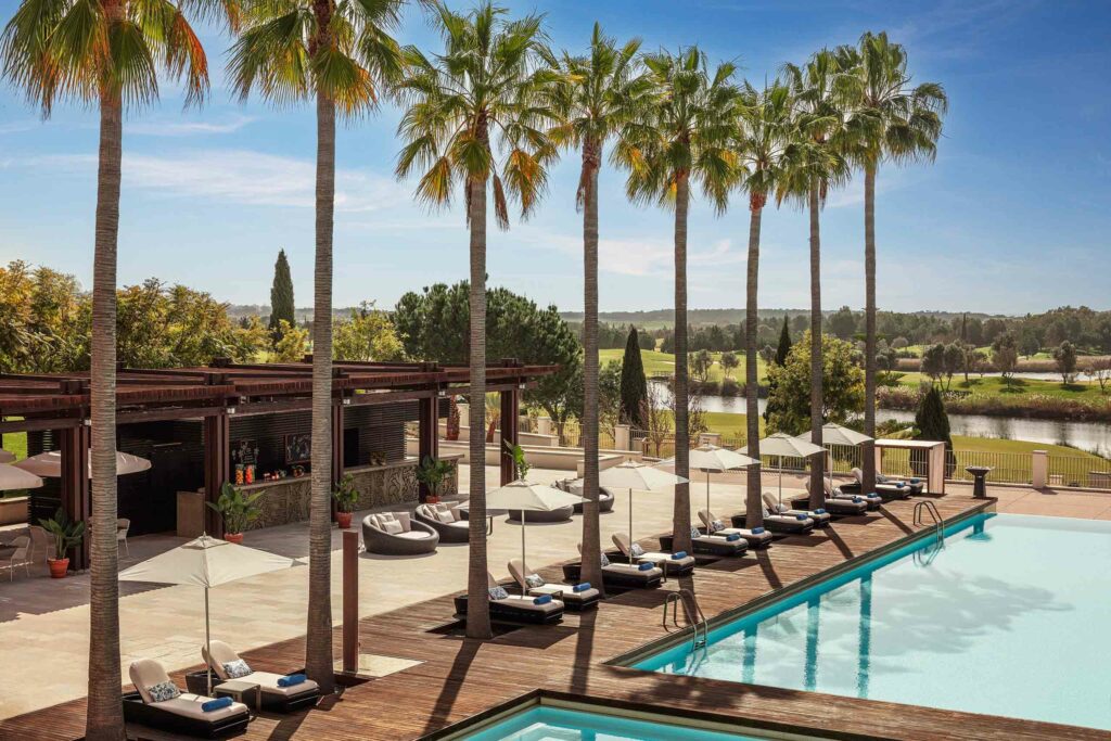 Palm trees line a pool at the Anantara Vilamoura Algarve Resort, Algarve, Portugal