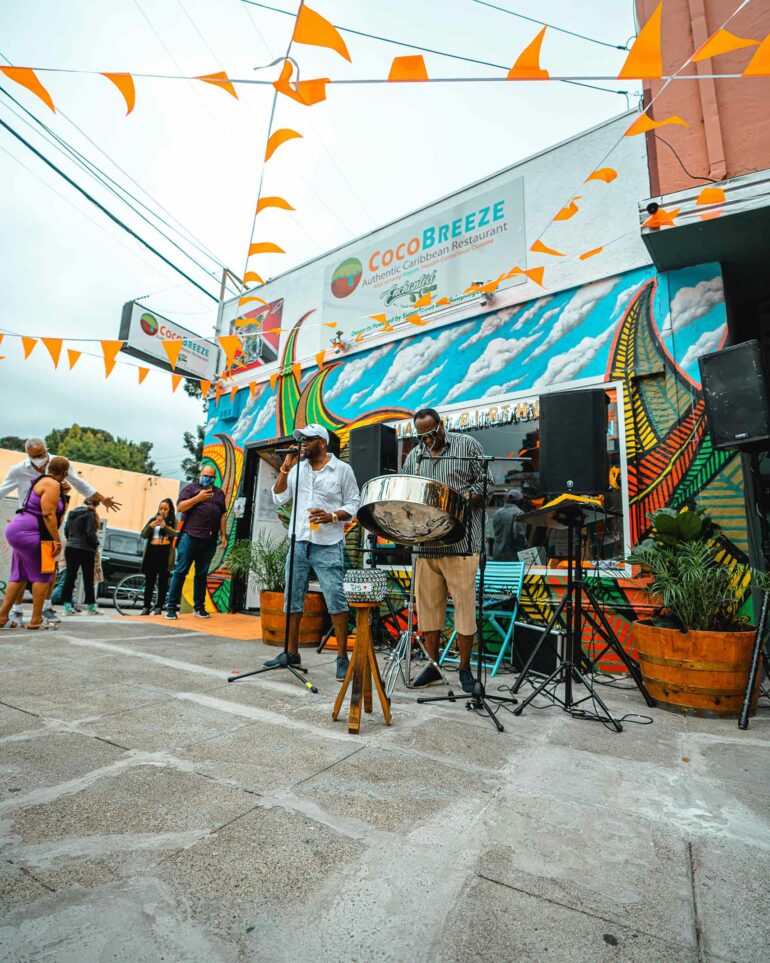 Musicians outside of Coco Breeze restaurant, Oakland, California, USA