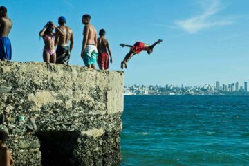 People diving in the sea in Salvador, Brazil