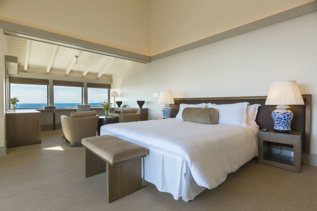 A spacious bedroom with ocean views at Heritage House Resort & Spa, Mendocino, California, USA.