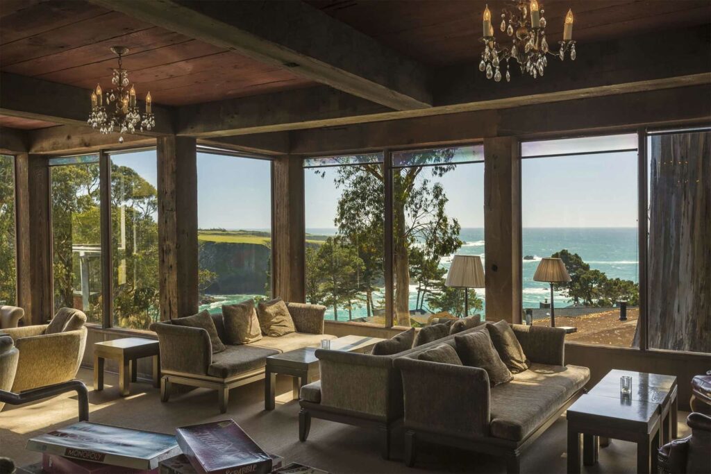 A stylish lounge space with sprawling views of the Mendocino coast at Heritage House Resort & Spa, Mendocino, California, USA.