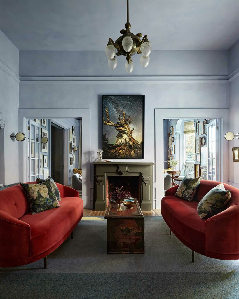 Living area with red sofas and artwork at The Madrona.