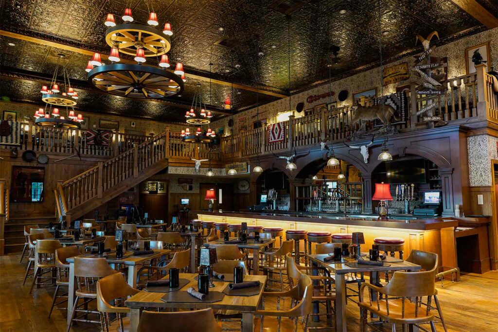 Western bar with moody lighting and dark wood furnishings.