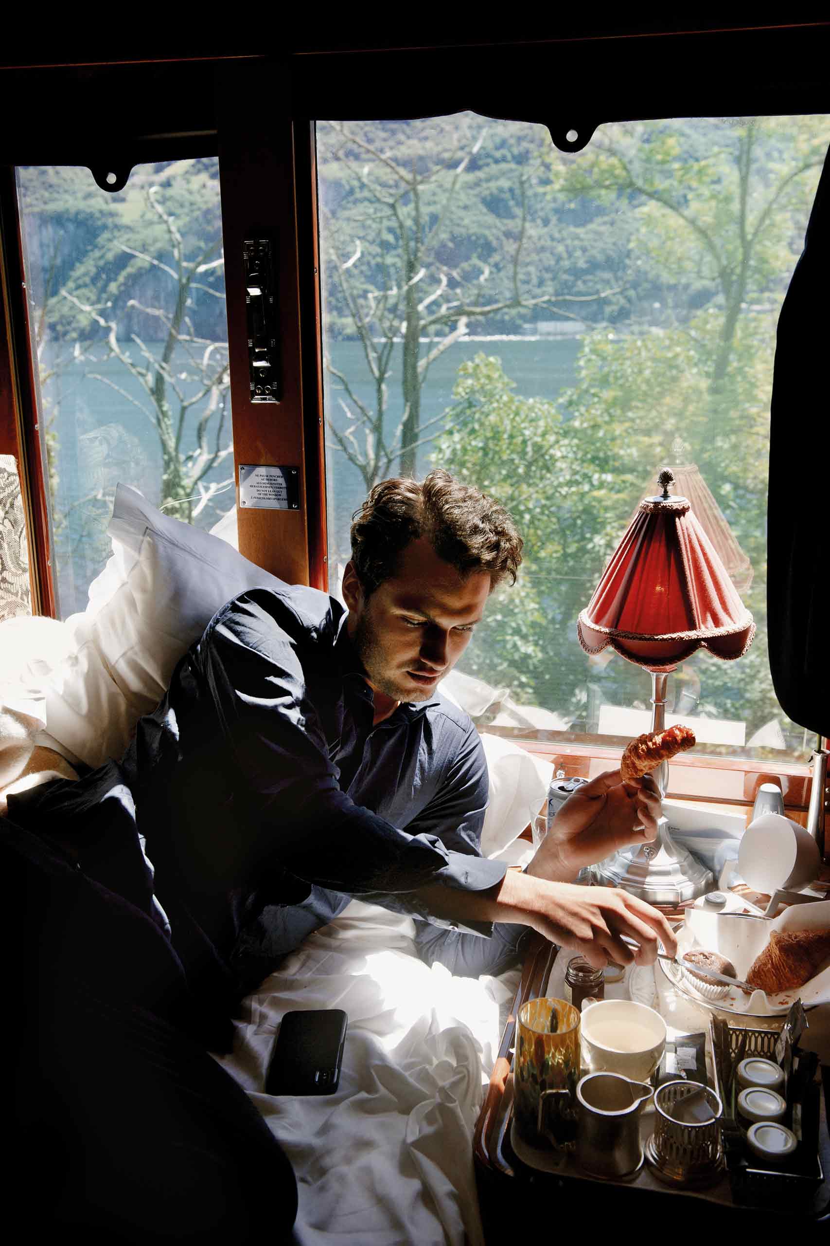 A male traveller enjoying breakfst aboard the Venice Simplon-Orient-Express.
