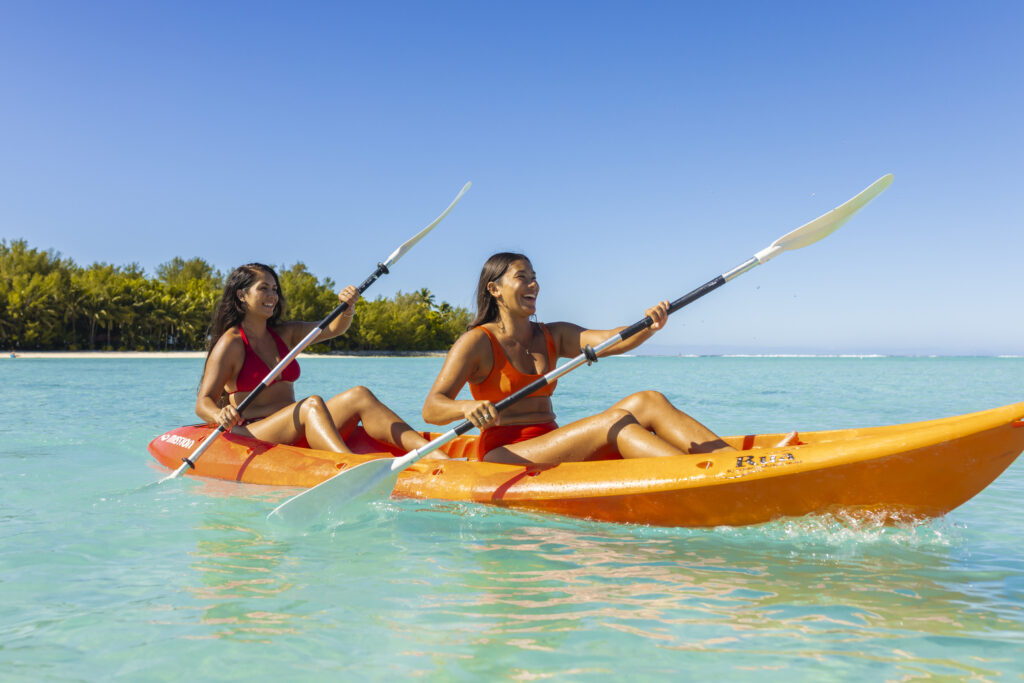 Two women kayaking in the Cook Islands.