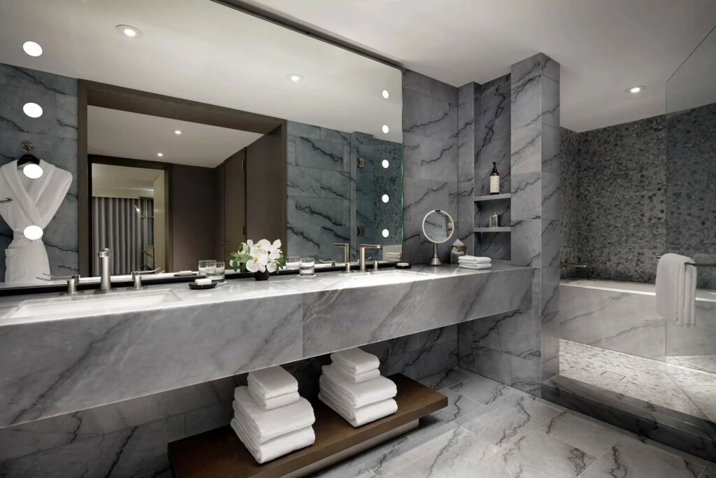 Grey marble bathroom with a large mirror at Fairmont Century Plaza, Los Angeles, California, USA
