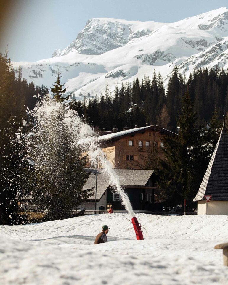 Benjamin Schneider clears snow outside Hotel Arlberg, Lech, Austria