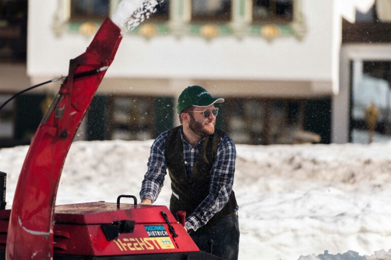 Benjamin Schneider clears snow in Lech, Austria