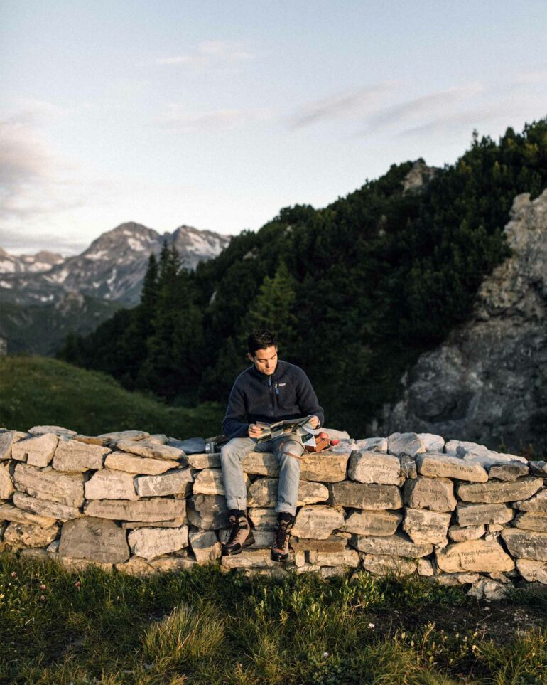 Patrick Krummenacher reading a magazine in the town of Lech, Austria