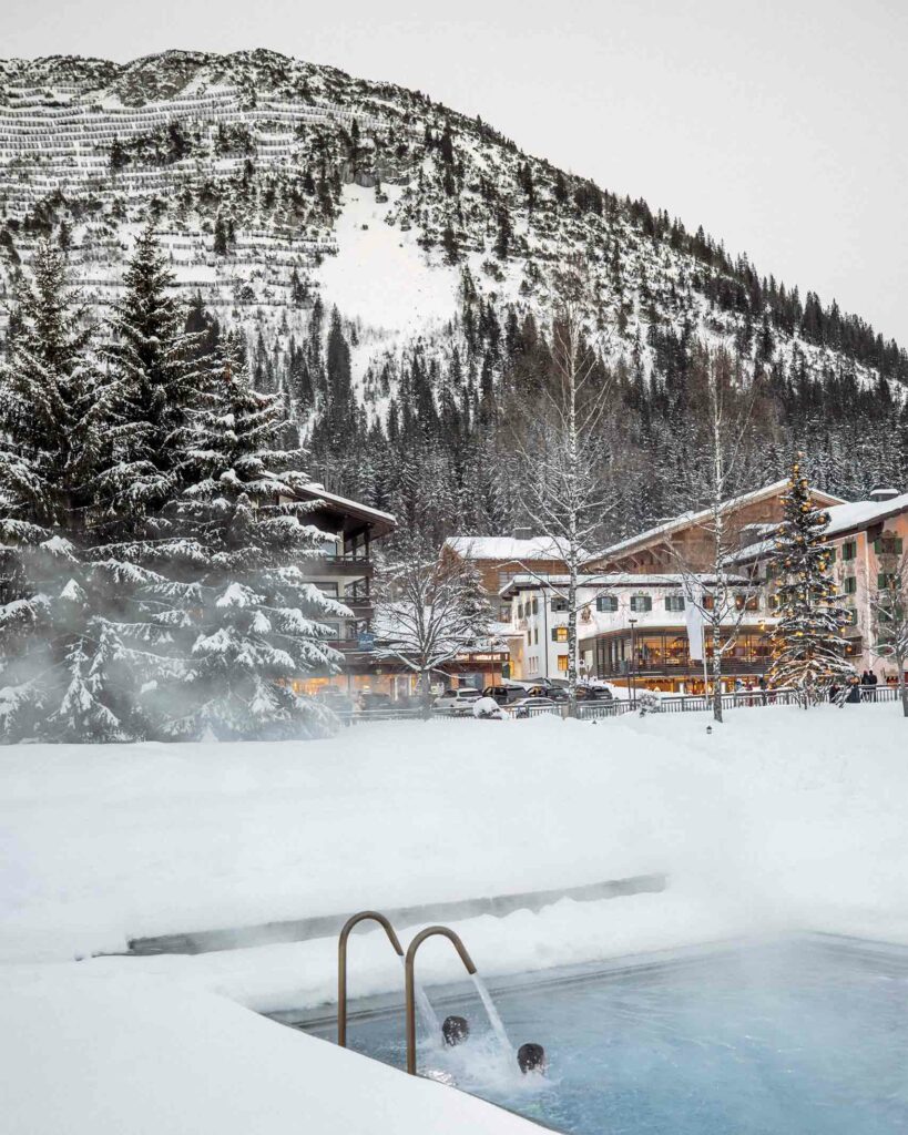 Outdoor pool surrounded by snow at Hotel Arlberg, Lech, Austria